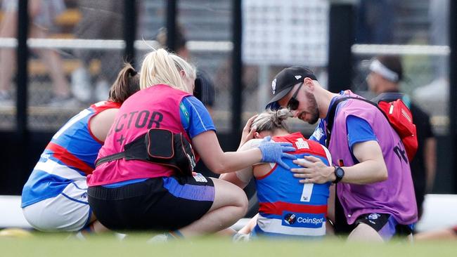 Deanna Berry is helped by medical staff after a head clash. Picture: Dylan Burns/AFL Photos via Getty Images