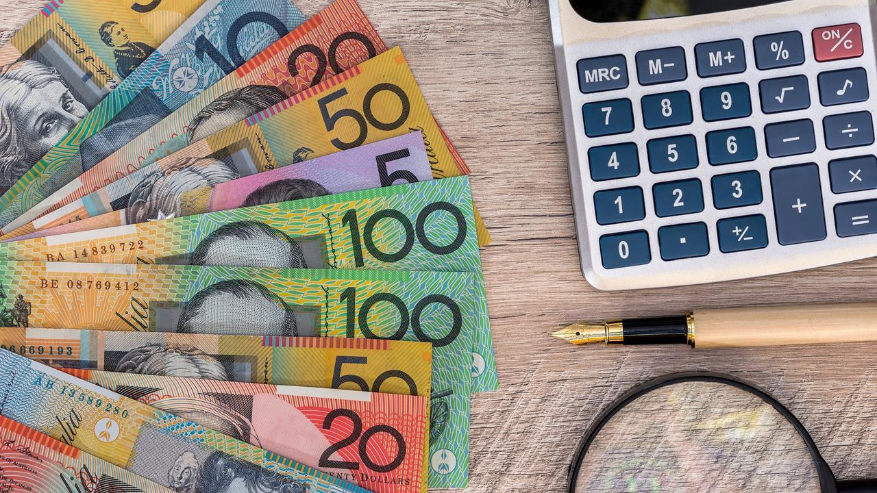 Australian dollars with calculator, pen and magnifier