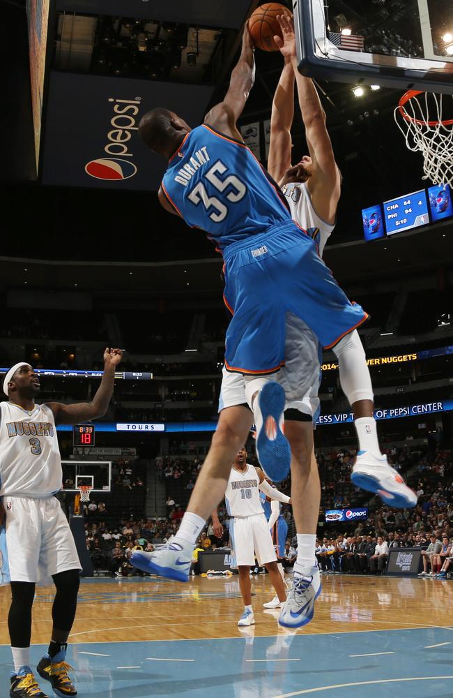 Kevin Durant, front, has his shot blocked by Denver Nuggets centre Timofey Mozgov, of Russia, in the first quarter of an NBA preseason basketball game in Denver, Wednesday, Oct. 8, 2014.