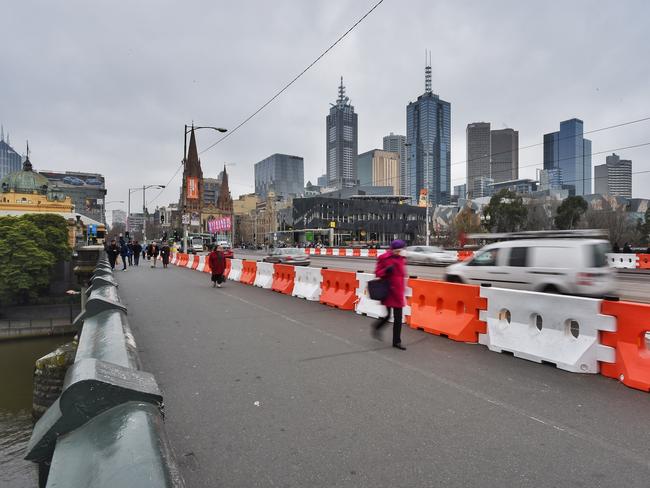 White and orange plastic bollards on Princes Bridge in the city. Picture: Tony Gough