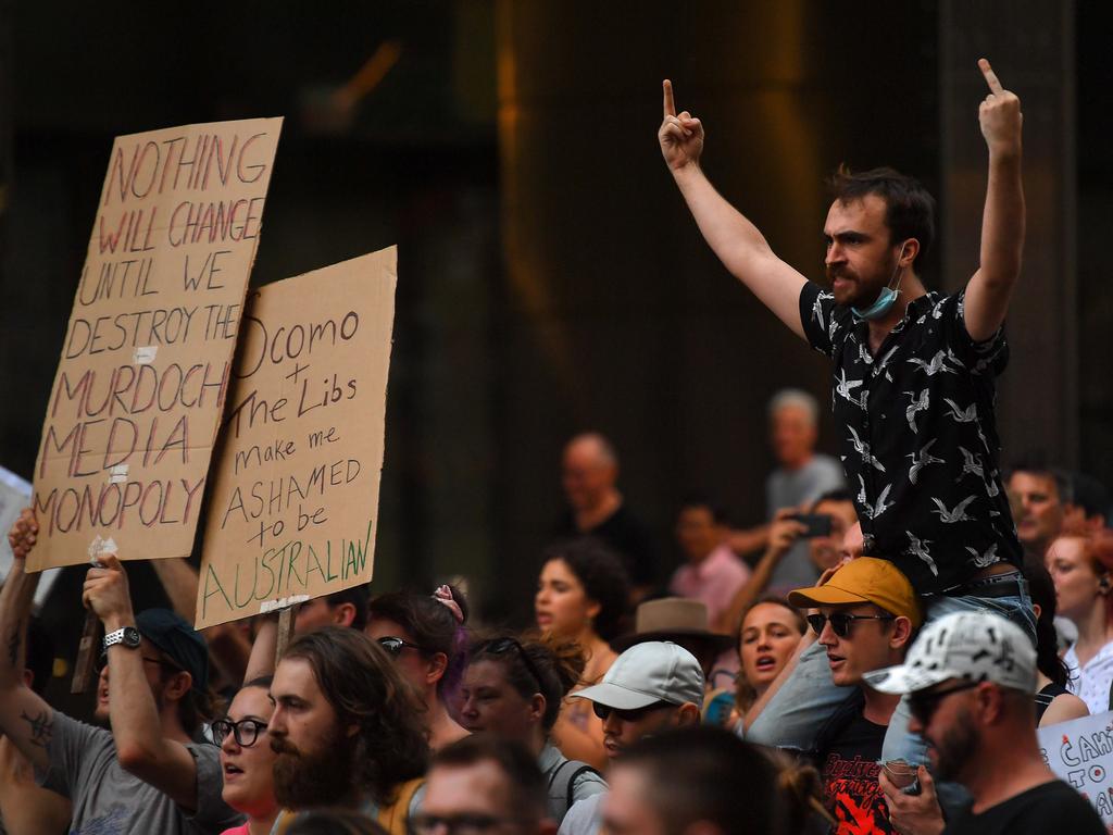 Protesters march with placards during a 'Sack ScoMo!' climate change rally in Sydney, Friday, January 10, 2020. (AAP Image/Steven Saphore)