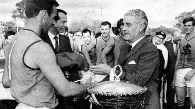 Sturt captain Bob Shearman receives the 1969 premiership flag and cup.