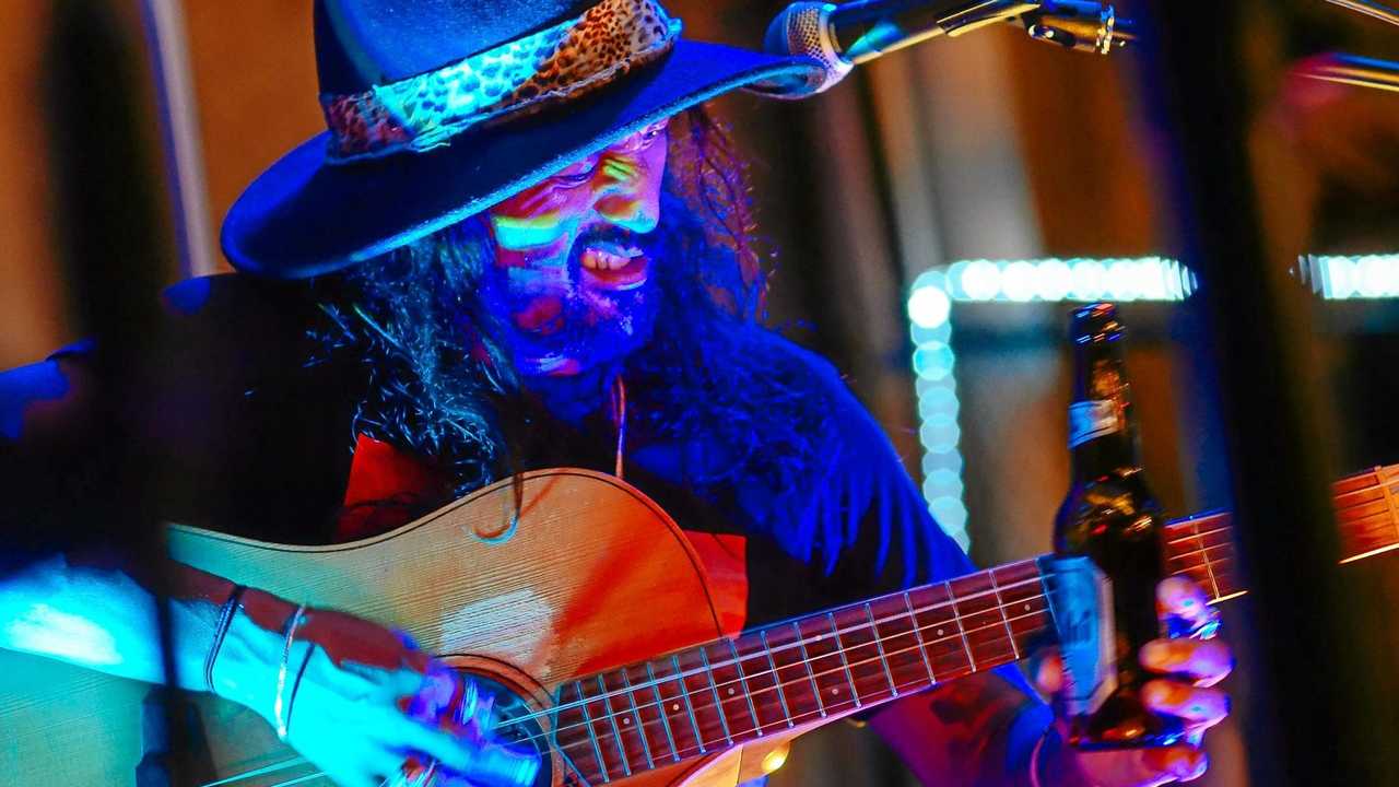 Beer bottle slide guitarist El Mariachi returns to Crow St The Courier Mail pic