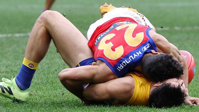 PERTH, AUSTRALIA - JULY 14: Liam Duggan of the Eagles lies concussed tackled by Charlie Cameron of the Lions during the 2024 AFL Round 18 match between the West Coast Eagles and the Brisbane Lions at Optus Stadium on July 14, 2024 in Perth, Australia. (Photo by Will Russell/AFL Photos via Getty Images)