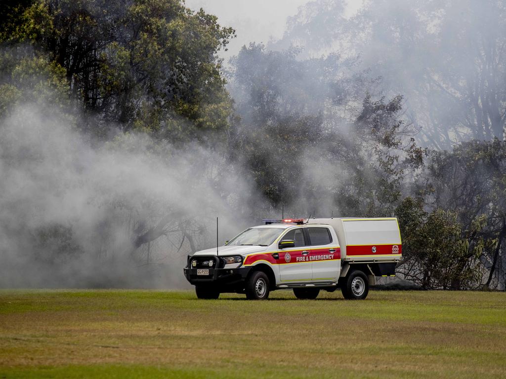 Smoke haze covers the Gold Coast Skyline from a grass fire at Carrara. Emergency services at St Michael's Collage, Merrimac. Picture: Jerad Williams