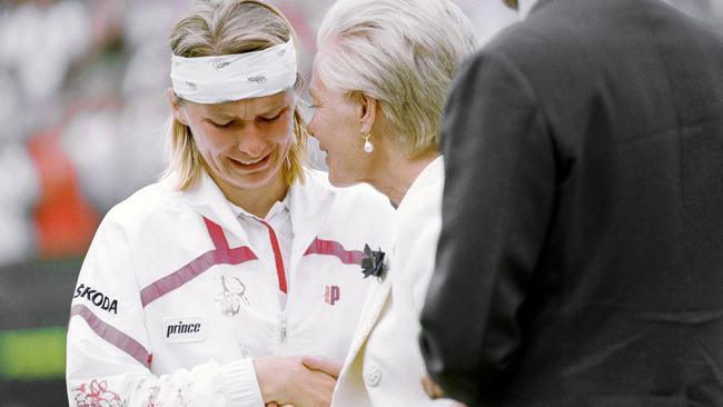 FILE - In this  July 3, 1993 file photo, Jana Novotna breaks down and weeps, as she accepts the loser's plate from the Duchess of Kent, after the Ladies' Singles Final on the Centre Court at Wimbledon, London.  The WTA says 1998 Wimbledon champion Novotna has died at the age of 49. The women's tennis body says Novotna died Sunday, Nov. 19, 2017, after a long battle with cancer.  (AP Photo/Dave Caulkin, File)