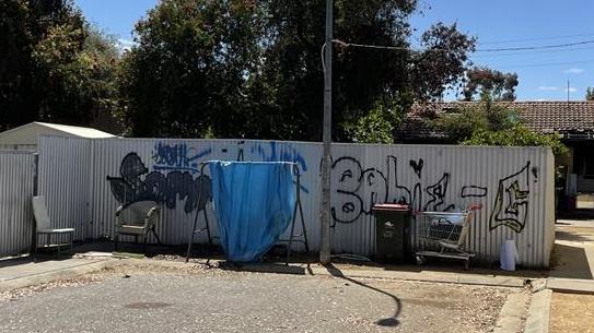 A graffiti covered tin fence in Stotts Court. Supplied