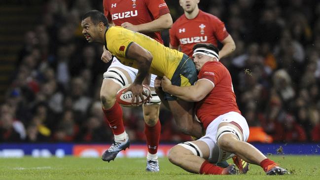 Aussie Kurtley Beale manages to get this one away, under the pump from a Welsh defender. Picture: AP