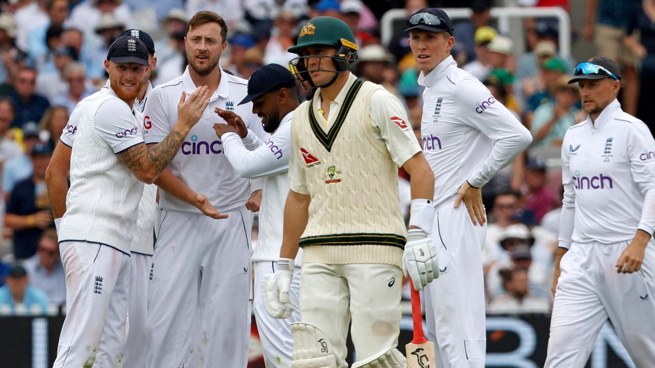 England's Jonny Bairstow and Ollie Robinson celebrate taking the wicket of Australia's Marnus Labuschagne. Photo by Ian Kington / AFP