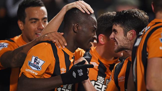 Dame N'Doye (C) of Hull City celebrates after scoring his team's second goal.