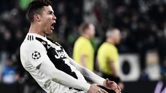 Juventus' Portuguese forward Cristiano Ronaldo celebrates after scoring 3-0 during the UEFA Champions League round of 16 second-leg football match against Atletico Madrid at the Juventus stadium in Turin. 