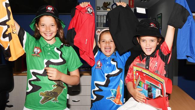 Alawa Primary School students Felicity Wedel, 10, Halle Wedel, 8, and Stella Wedel, 6, with some of the items that Back to School vouchers can help buy. Picture: Katrina Bridgeford