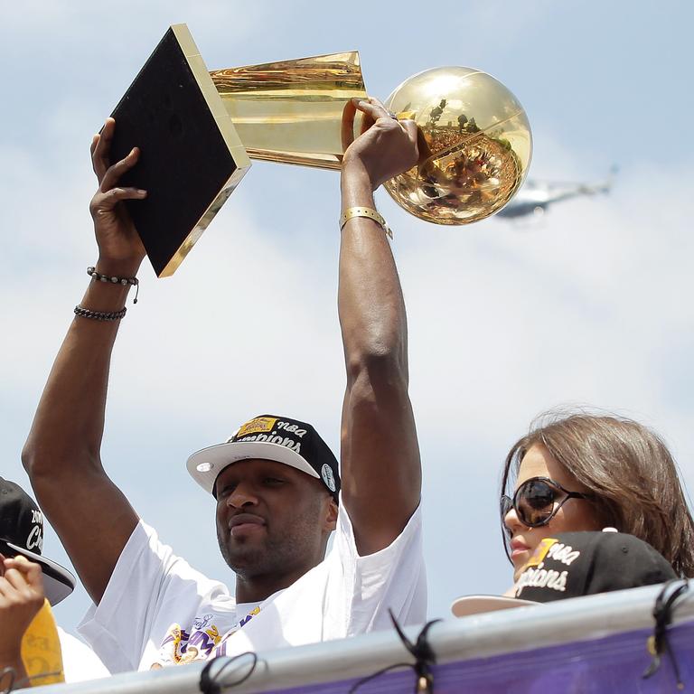 Los Angeles Lakers power foward Lamar Odom hoists the championship trophy while riding in the victory parade for the the NBA basketball champion team on June 21, 2010 in Los Angeles. Picture: Getty