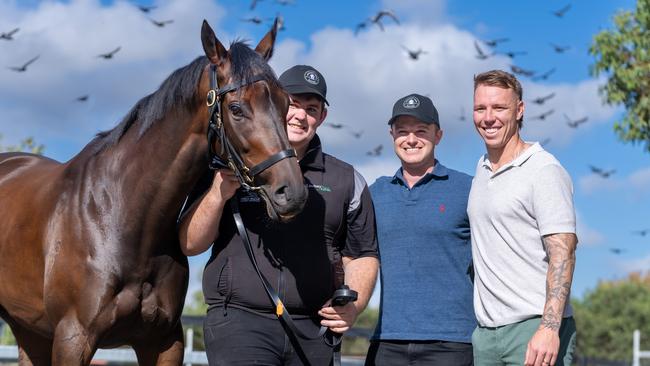 Mr Brightside with strapper Will Evans (left), trainer Ben Hayes, and Western Bulldogs star James Harmes. Picture: Jay Town/Racing Photos via Getty Images