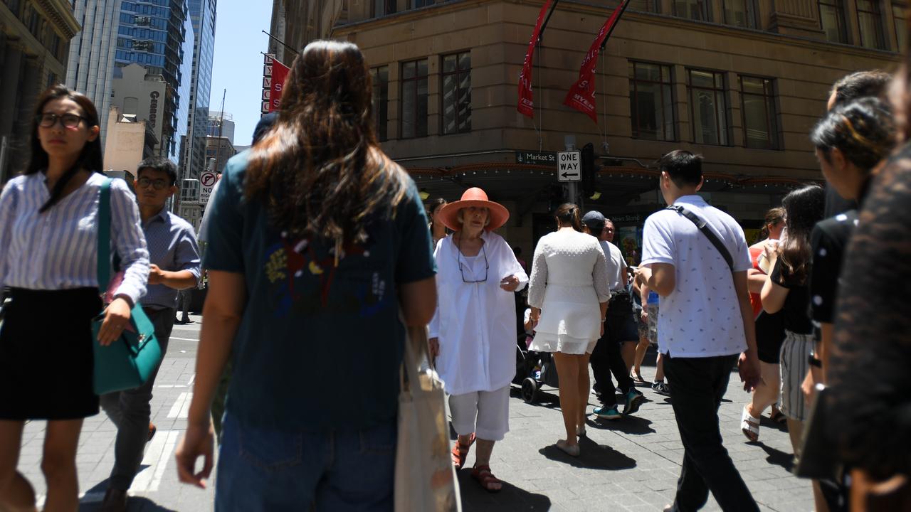 Pedestrians are seen in Sydney’s CBD during a scorching day on Thursday. Picture: AAP/Paul Braven