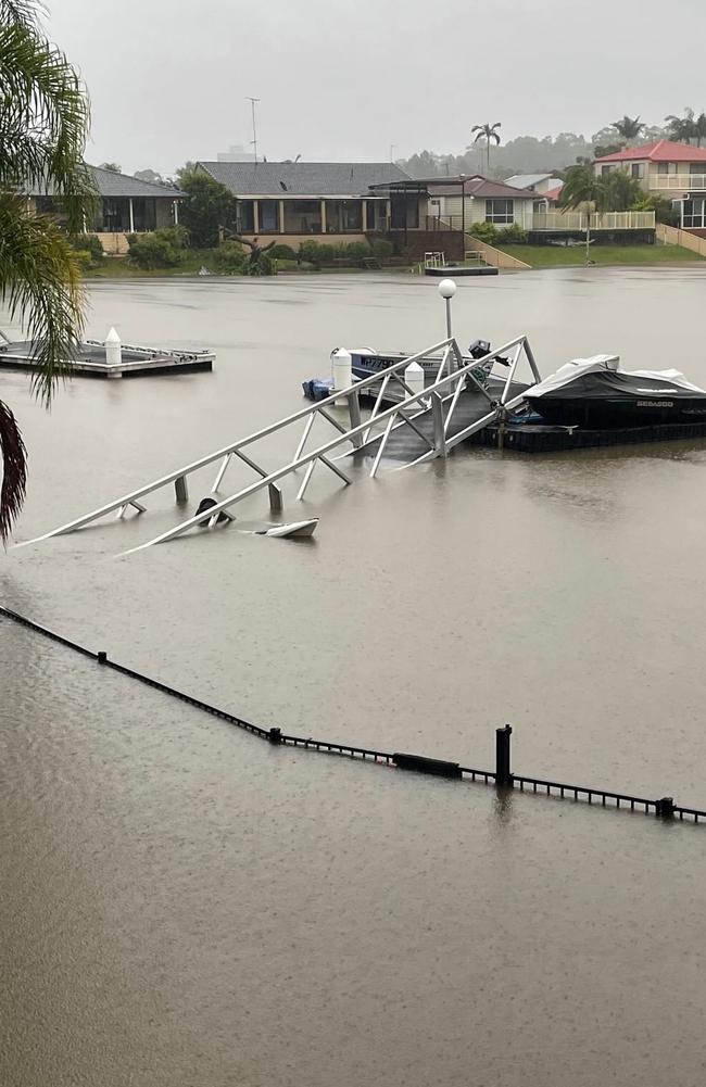 Gold Coasters living by the water woke on Monday to flooded rising water levels, with some finding their properties, jetties and pontoons submerged or swept away after heavy rain drenched the city overnight. Photo: Olivia Scott.