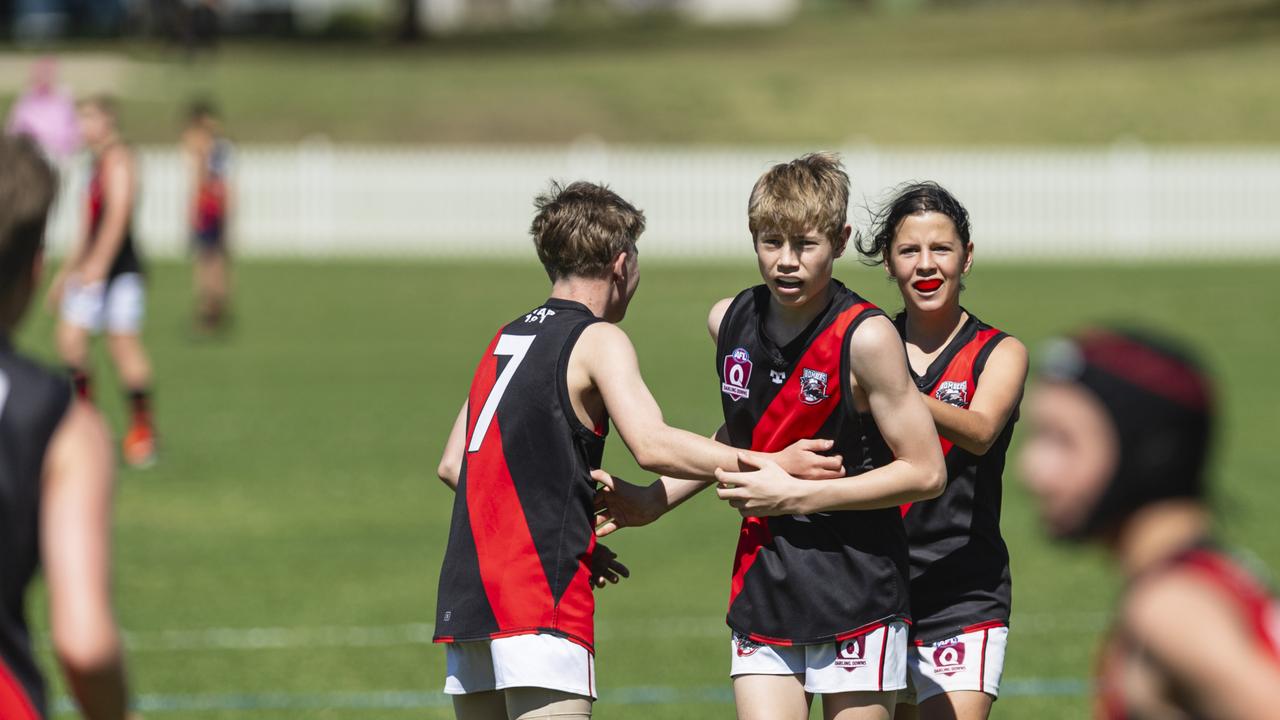 South Toowoomba Bombers players including Balin Groom (centre) celebrate a goal against University Cougars in AFL Darling Downs under-14 mixed grand final at Rockville Park, Saturday, August 31, 2024. Picture: Kevin Farmer