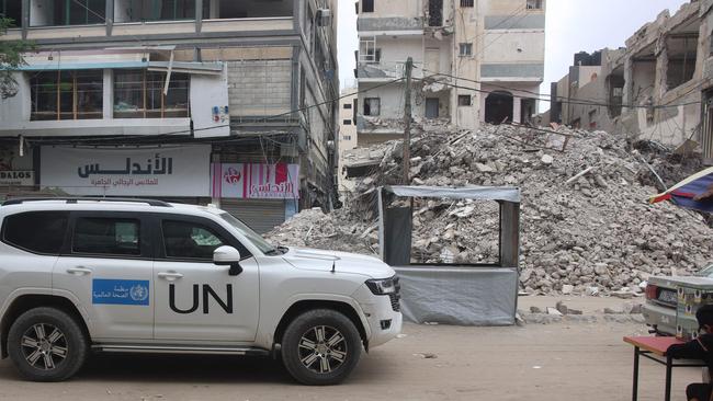 A United Nations vehicle is parked next to the rubble of a destroyed building in Gaza City on Monday. Israel has taken control of about 30 per cent of the strip. Picture: AFP
