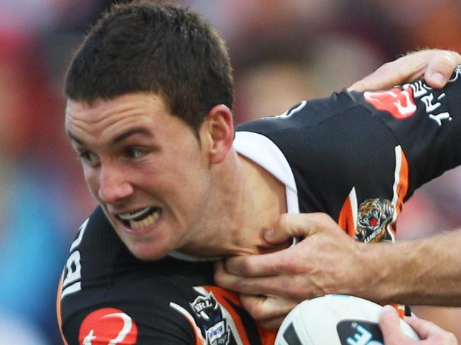 Trent Merrin and Beau Scott bring down Tim Moltzen during St George-Illawarra Dragons v Wests Tigers NRL game at WIN Jubilee Oval at Kogarah, Sydney.