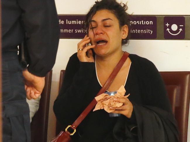 A relative of the victims of the EgyptAir flight 804 reacts as she makes a phone call at Charles de Gaulle Airport outside of Paris, Thursday, May 19, 2016. Egyptian aviation officials say an EgyptAir flight from Paris to Cairo with 66 passengers and crew on board has crashed. (AP Photo/Michel Euler)