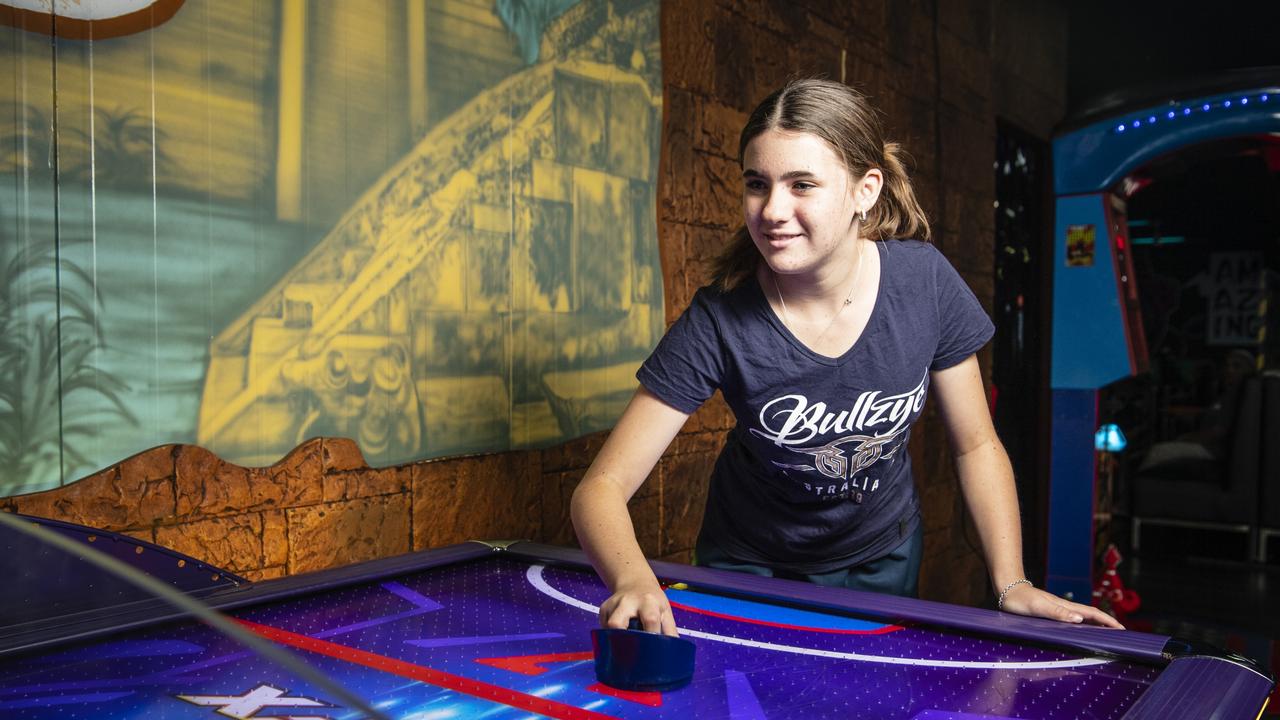 Taylor Hopkins plays air hockey at iPlay Toowoomba Bowl during the school holidays, Monday, January 9, 2023. iPlay is open on King’s Birthday public holiday