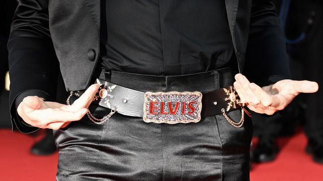 Australian director Baz Luhrmann wears a belt with the name Elvis as he arrives for the screening of the film.