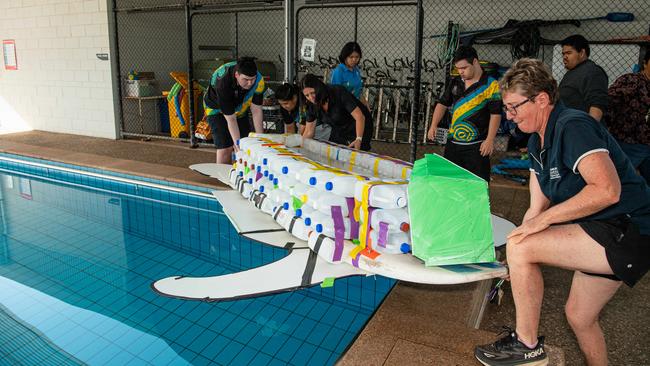 Henbury School students Christina Cantoria, Miley Lam, Jacob Gil, Owen Corpus, and Andrew Perry prepare their boat for the Beer Can Regatta, 2024. Picture: Pema Tamang Pakhrin