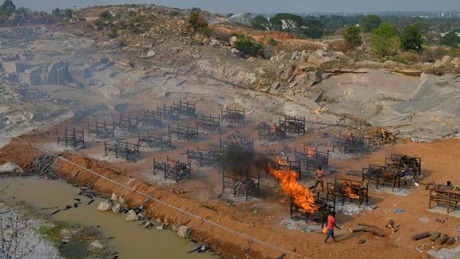 Burning pyres of the victims who died of COVID-19 coronavirus are pictured at an open air crematorium set up inside a defunct granite quarry on the outskirts of Bangalore, India. Picture: Manjunath Kiran / AFP