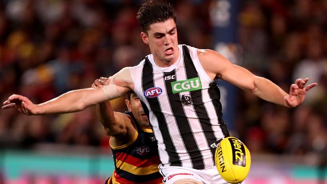 Eddie Betts tries to tackle Collingwood’s Brayden Maynard before leaving the field with a hamstring injury on Friday night. Picture: James Elsby/AFL Media/Getty Images