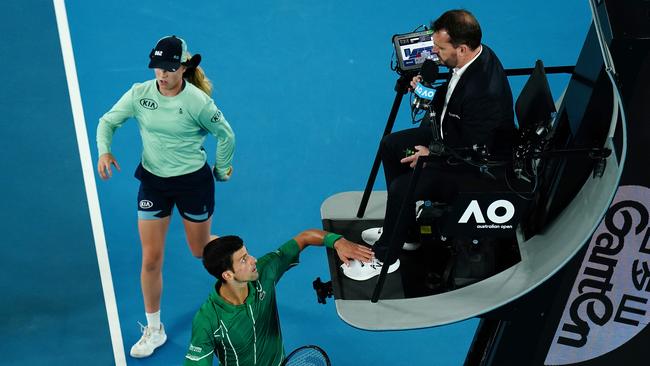 Novak Djokovic touches chair umpire Damien Dumusois. Picture: AAP/Dave Hunt