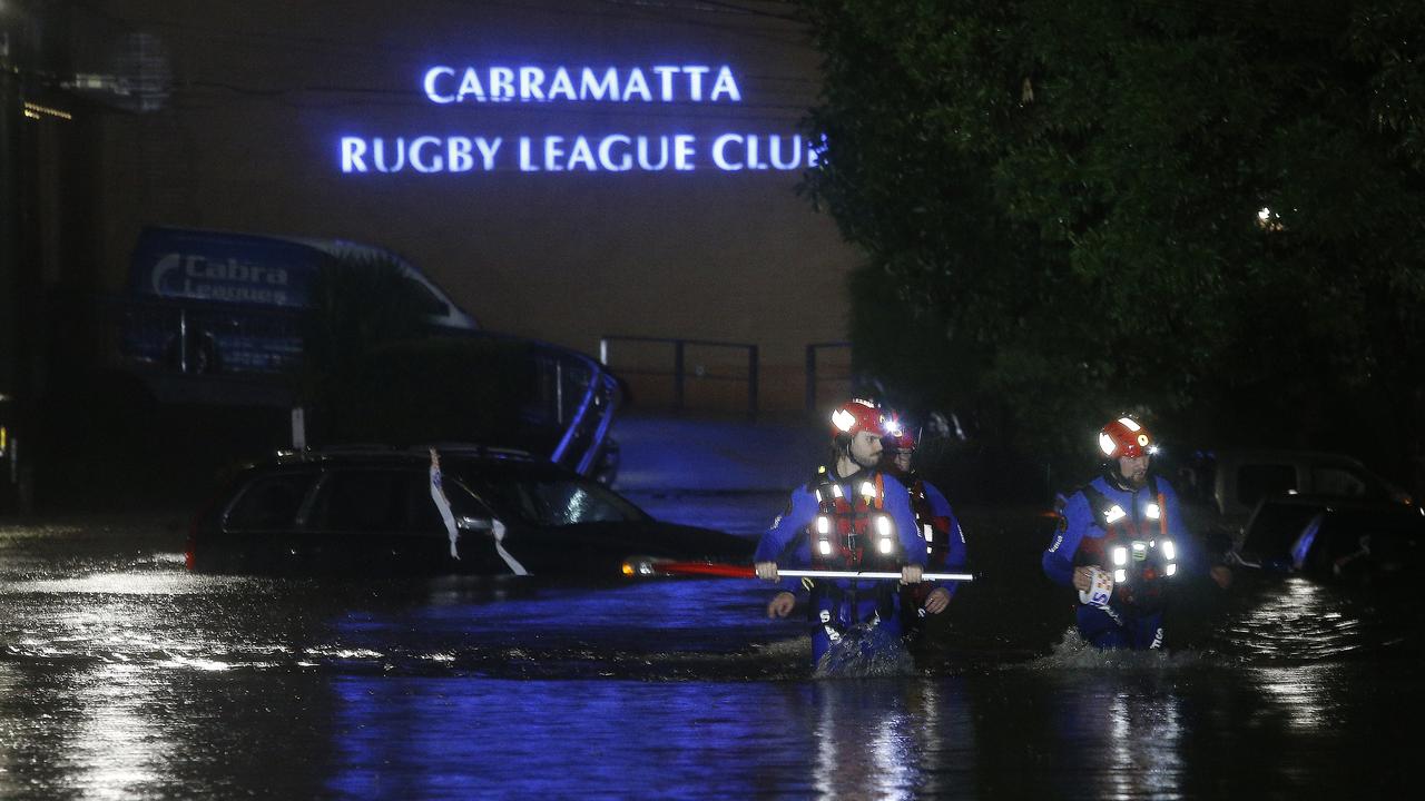 SES crew checking trapped cars in Church St, Cabramatta. Picture: John Appleyard