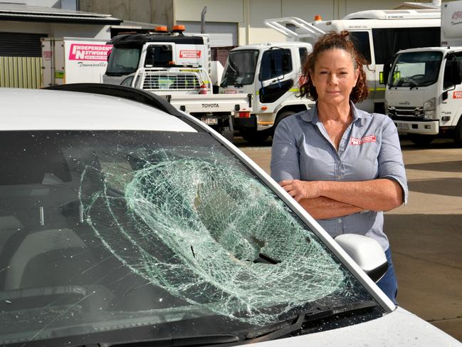 Debbie Thompson at Independent Network in Garbutt with vehicles damaged by a vandal. Picture: Evan Morgan