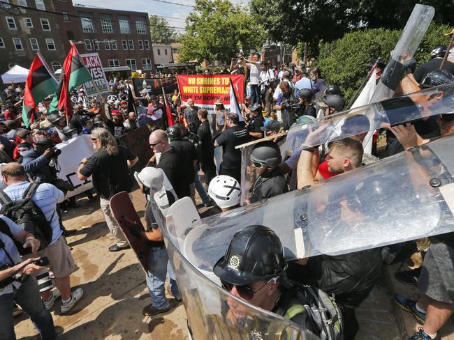 White nationalist demonstrators use shields as they clash with counter-demonstrators at the entrance to Lee Park in Charlottesville, Virginia, on Saturday. Picture: AP Photo/Steve Helber