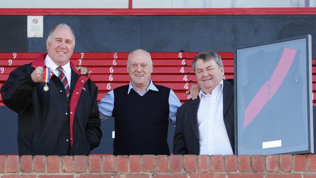 Ken Eustice (middle) presenting his 1962 Magarey Medal to West Adelaide Football Club’s Hall of Fame via then president Paul Sperling and his old jumper to David Shipway.