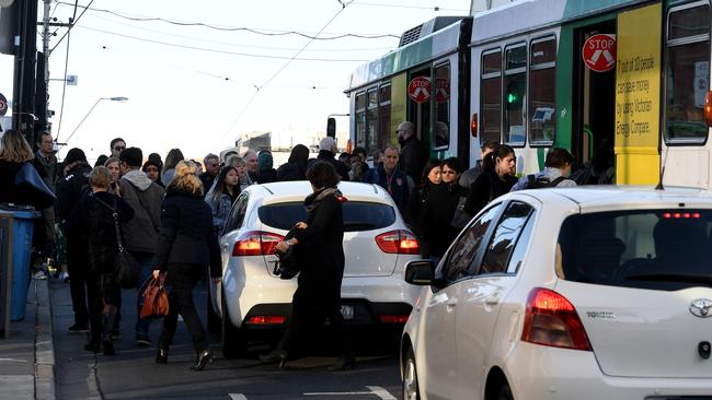 Commuters crowd on to a Toorak Rd tram outside congested South Yarra station on May 10. Picture: Andy Brownbill