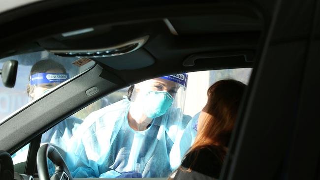 An Australian Clinical Labs team member tests a driver at a Geelong COVID drive-through testing site. Picture: Alan Barber