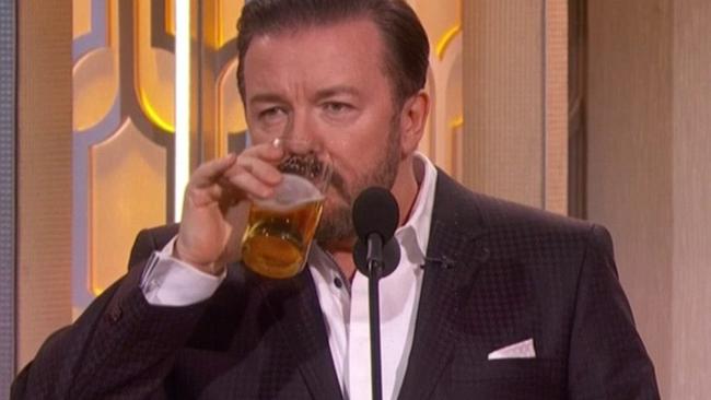 Ricky Gervais drinking knocks back a beer onstage at the 2016 Golden Globe Awards. Picture: NBC
