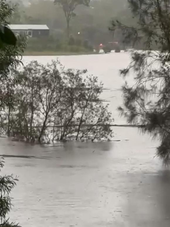 Mudgeeraba Rd is underwater as intense rainfall lashes the Gold Coast. Picture: Supplied/Facebook