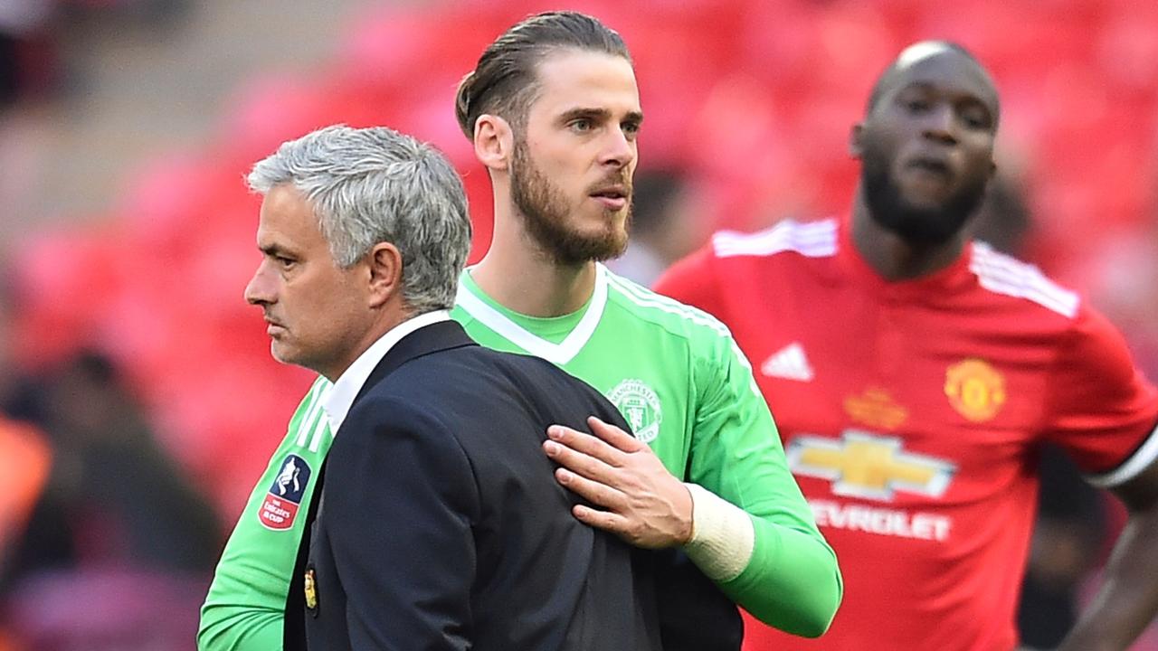Jose Mourinho reacts with Manchester United goalkeeper David de Gea after losing the English FA Cup final to Chelsea.