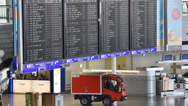 A vehicle used for defusing bombs drives through the evacuated Hall A of Terminal 1. Picture: AP