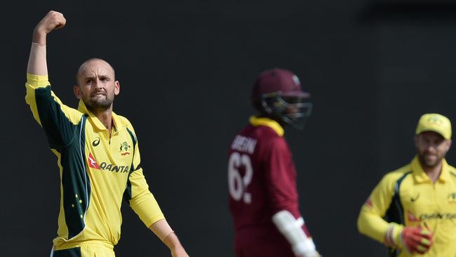 Australia's Nathan Lyon catches out the West indie's Sulieman Benn during a One-day International (ODI) cricket match between the West Indies and Australia in the Tri-Nation Series in Georgetown, Guyana on June 5, 2016.  / AFP PHOTO / ANDREW CABALLERO-REYNOLDS