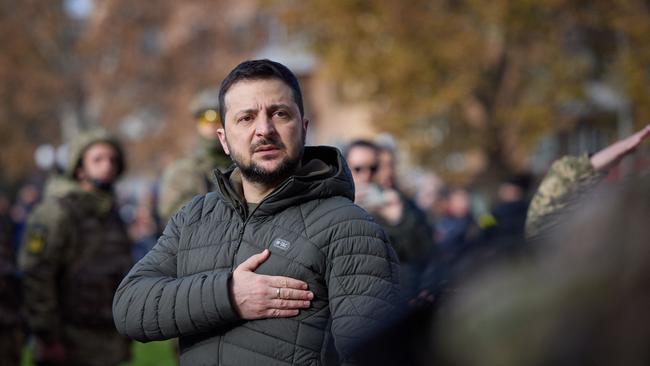 Ukrainian President Volodymyr Zelenskyy taking part in the flag laying ceremony during his visit to the newly liberated city of Kherson. Picture: AFP