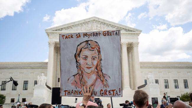 A person holds a sign in support of Swedish environment activist Greta Thunberg outside the US Supreme Court in Washington on September 18, 2019. Picture: AFP