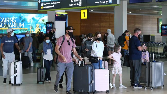 Passengers collect their baggage at Cairns Airport arrivals terminal after arriving on a Jetstar flight. Picture: Brendan Radke