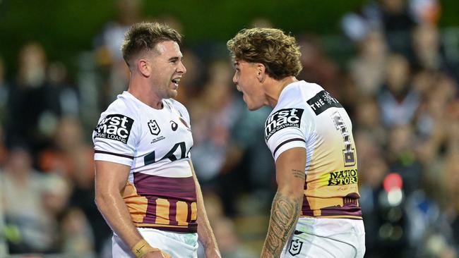 SYDNEY, AUSTRALIA - APRIL 27: Reece Walsh (R) of the Broncos celebrates after scoring a try during the round eight NRL match between Wests Tigers and Brisbane Broncos at Campbelltown Stadium, on April 27, 2024, in Sydney, Australia. (Photo by Izhar Khan/Getty Images)