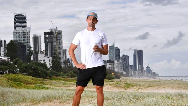 Tobias Diamandopoulos with a coffee on the beach at Mermaid Beach. The price of your morning coffee is tipped to break the $20 mark by the end of 2025. Picture: John Gass.