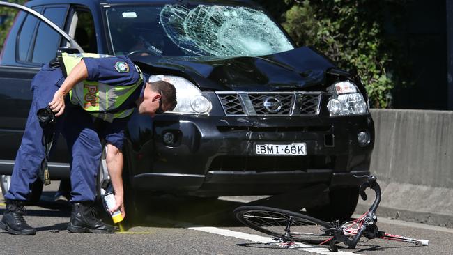 Police investigate the scene of an accident where a car has hit a group of six cyclists on Southern Cross Drive in Sydney’s east.