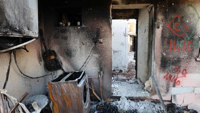 A burned washing machine stands among the debris of a house destroyed during the October 7 attack by Hamas militants in kibbutz Kfar Aza in southern Israel. Picture: AFP