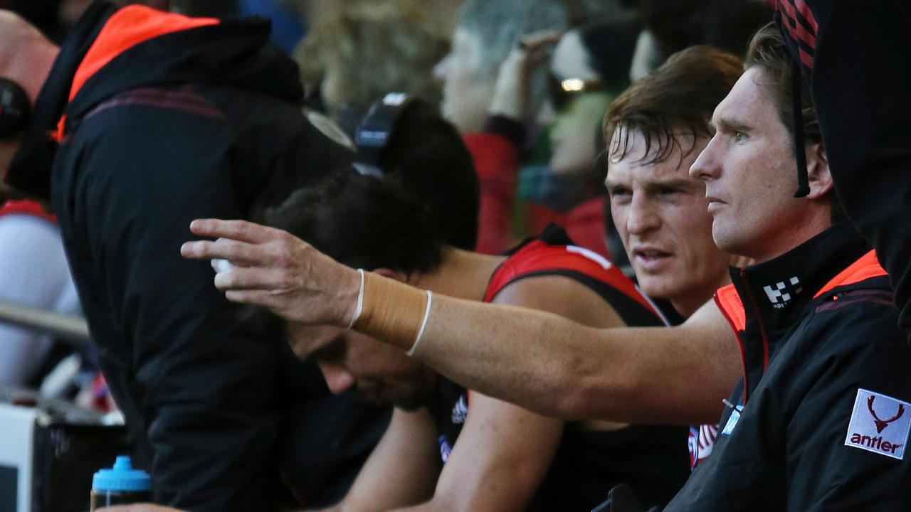 James Hird chats to former Bomber Brendon Goddard during a match.