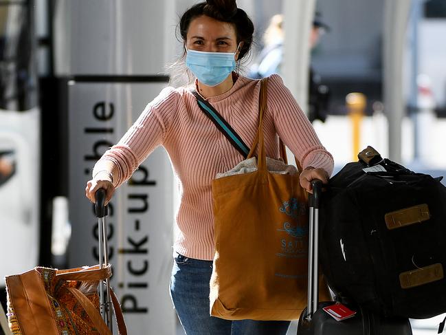 Australian residents returning from India are ushered towards waiting busses for the beginning of their 14-day imposed quarantine, after arriving at Sydney International Airport in Sydney, Friday, May 8, 2020. (AAP Image/Bianca De Marchi) NO ARCHIVING